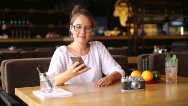 Mixed race woman picks up her smartphone, facial recognition system gets face detection scanning to unlock the device with overlay graphics. Infrared camera scans female face. Biometry. — Stock Video