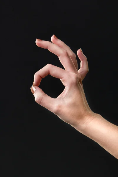 Ok gesture with hand on a isolated dark background — 图库照片