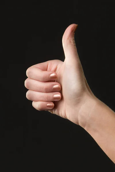 Daumen hoch weibliches Handzeichen isoliert auf dunklem Hintergrund — Stockfoto