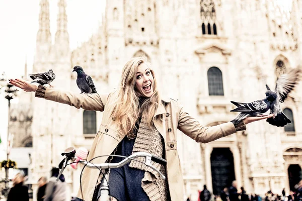 Woman playing with pigeons