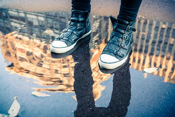 Woman walking on the puddle — Stock Photo, Image