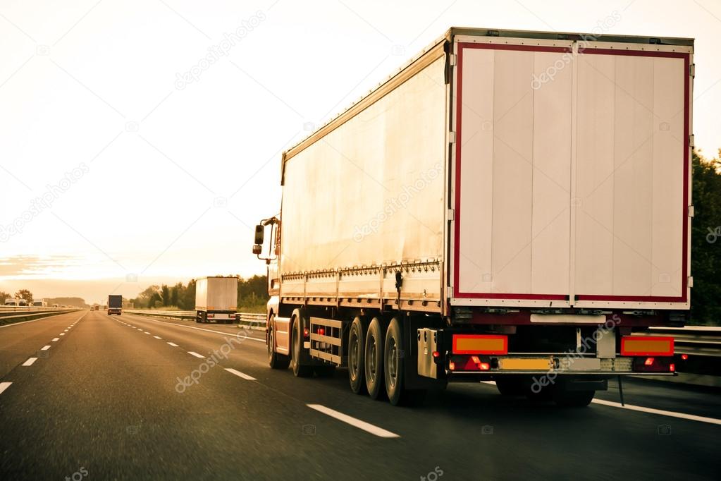 side view of trucks on highway