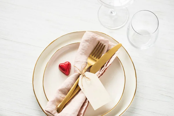 Romantic table setting with candy heart.