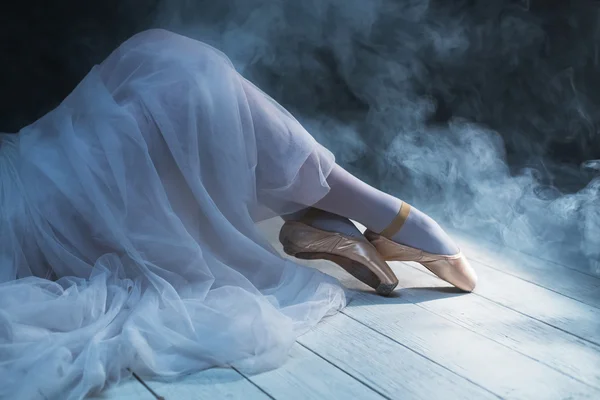The feet of sitting ballerina in the smoke — Stok fotoğraf