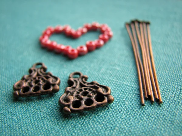 Red beads in form of heart, making of earrings, handmade jewelry Stock Picture