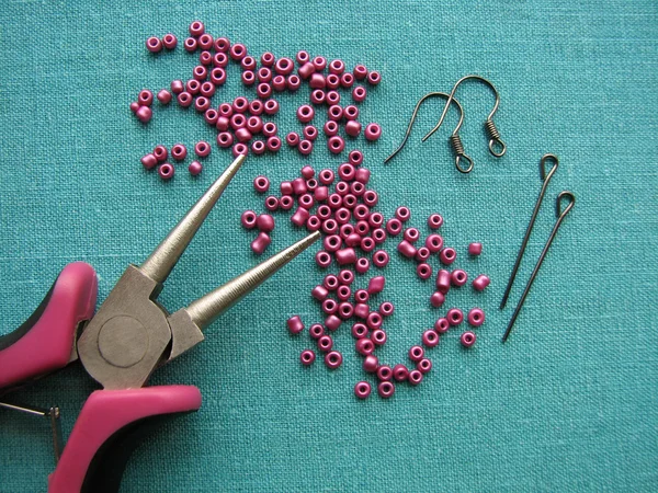 Beads, furniture and tools for making earrings, handmade jewelry Stock Image