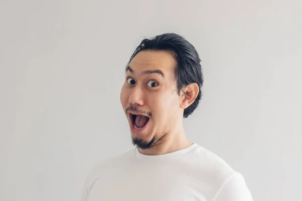 Funny grinning smile face of man in white t-shirt and grey background. — Stock Photo, Image