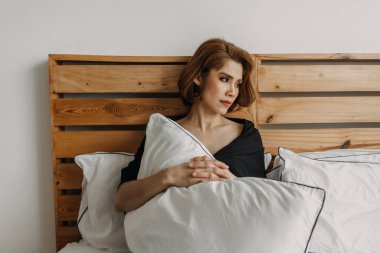 Makyaj yapan kadın yatakta dinleniyor. Yalnızlık kavramı.