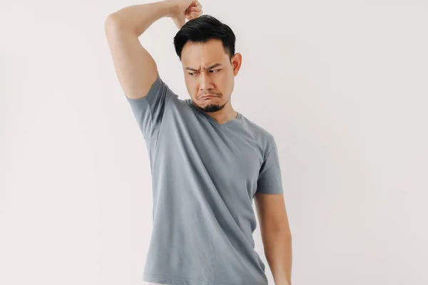 Asian man smells his bad odor armpit isolated on white. — Stock Photo, Image