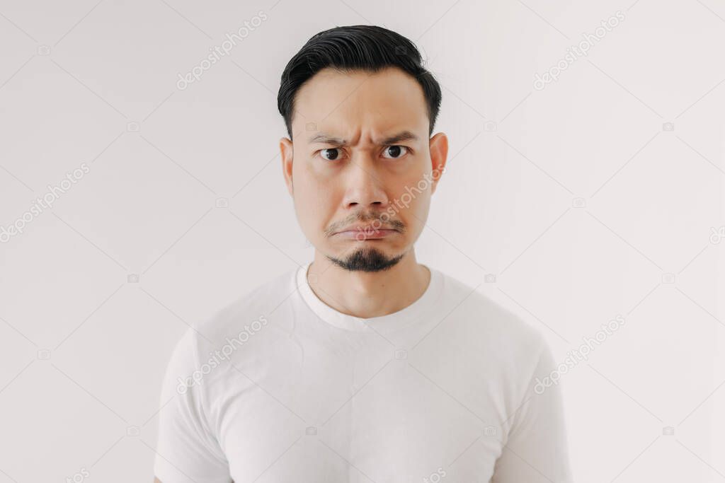 Grumpy face man in white t-shirt isolated on white background.