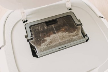 Elektrikli süpürgeden kirli tozu çıkarıyorum..