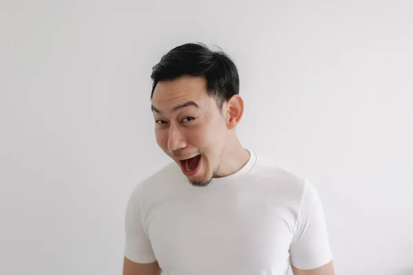 Funny grin smile face of man in white t-shirt isolated on white wall. — Stock Photo, Image