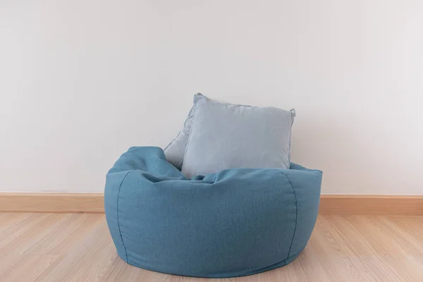 Bean bag in a clear living room with wooden floor and clear white wall. — 图库照片