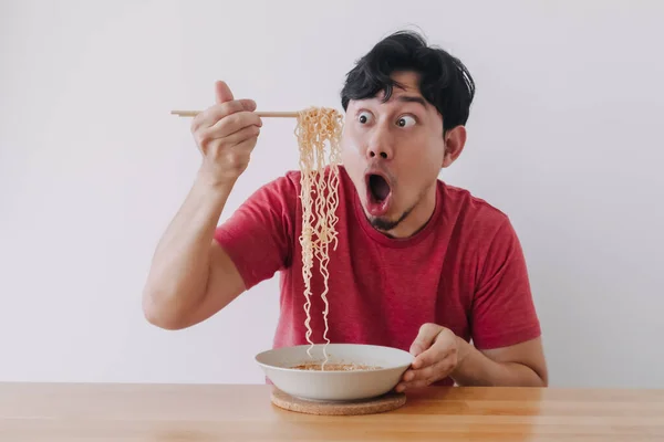 Wow and surprised funny face of man eat instant noodle. — Stock Photo, Image