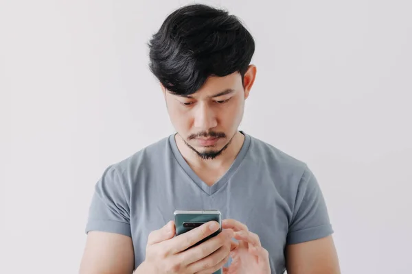 Asian Man Is Playing Mobile Game Seriously. Stock Photo, Picture