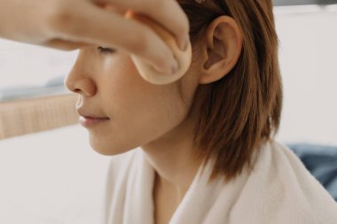 Makyajcı kadın işte ve modeline makyaj yapıyor..