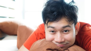 Happy Asian man wake up. clipart