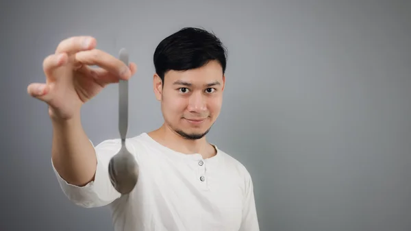 An Asian man with spoon. — Stock Photo, Image