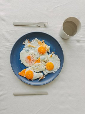 A vibrant and colorful breakfast scene featuring perfectly fried eggs, ideal for food blogs and culinary content