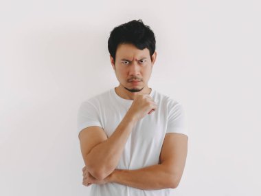 Taylandlı erkek, kısa siyah saçlı ve ortalama yapılı, elleri çenesinde, düz duvara yaslanmış, Asyalı kökenli.