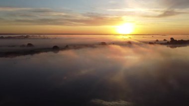 Misty summer morning over the river