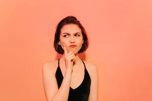 Thoughtful Young Woman Looking Away Holding Hand Face Orange Background — Stock Photo, Image