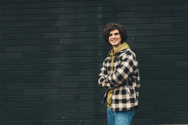 Cheerful Man Standing Crossed Arms Black Brick Wall — Stock Photo, Image