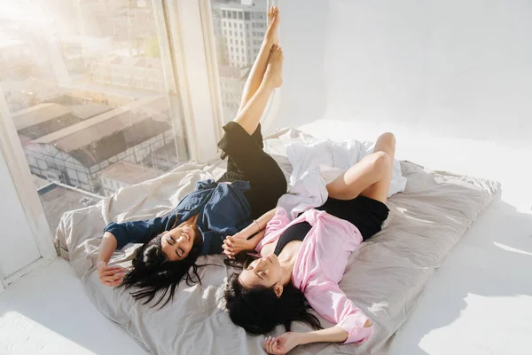 High angle view of armenian women lying on white bedding in sunshine — Stock Photo
