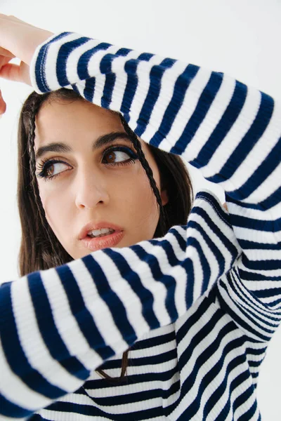 Trendy armenian woman in striped pullover looking away isolated on white — Stock Photo