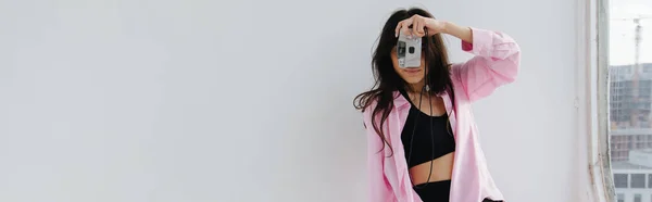 Young armenian woman taking photo on digital camera on white, banner — Stock Photo