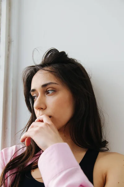 Dreamy armenian woman looking away while holding hand near face — Stock Photo