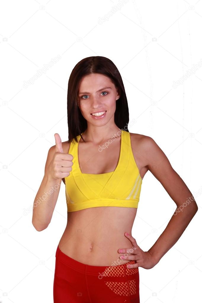 Beautiful girl athlete showing thumbs up and smiling