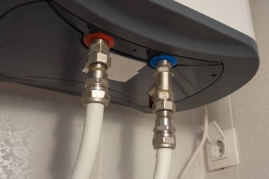 connecting cold and hot water to the water heater close-up