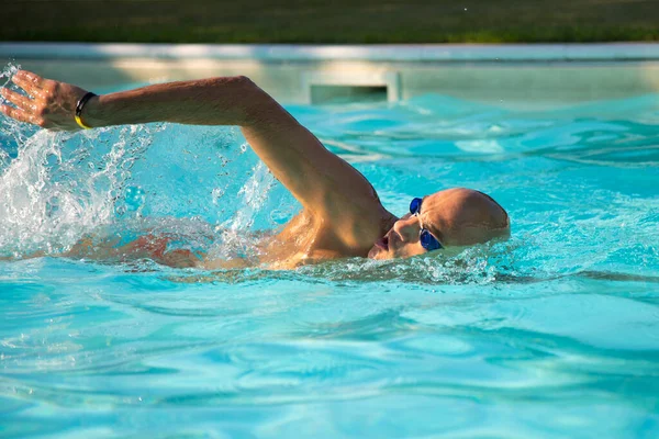 male non-professional swimmer Swimming in the pool on vacation