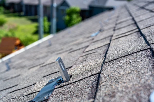 Residential asphalt shingle roof with metal anchors installed for the installation of a solar panel rail and racking system — Stock Photo, Image