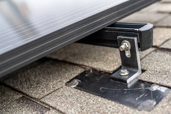 Rail, bracket, and anchor to a solar panel installed on a asphalt shingle roof — Stock Photo, Image