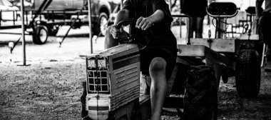 Selective focus on a pedal tractor pull and sled at a county fair. High quality photo