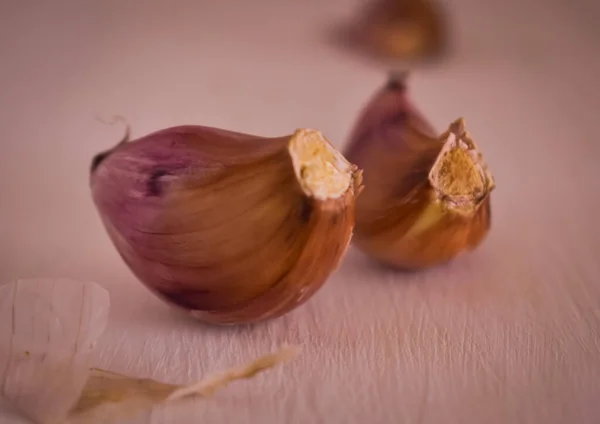 Beyaz masada bir sürü mor sarımsak var.