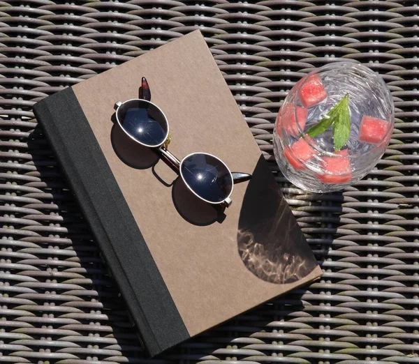 time to relax in the sun with a book and a chilled glass of watermelon infused ice water