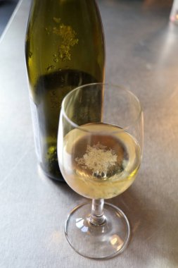 tartrate crystals in a glass of white wine clipart