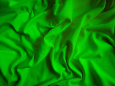 Yeşil buruşuk kumaş arka plan. Dalgalı kumaş dokusu