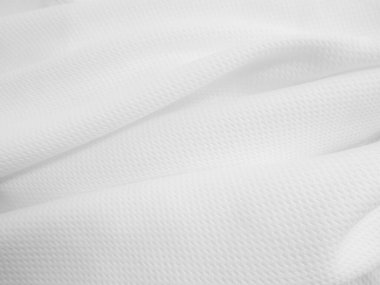 Close-up wavy cloth. White crumpled fabric background