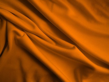Turuncu buruşuk kumaş arkaplan. Dalgalı kumaş dokusu
