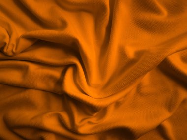 Turuncu buruşuk kumaş arkaplan. Dalgalı kumaş dokusu