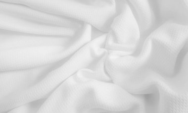 Close-up wavy cloth. White crumpled fabric background