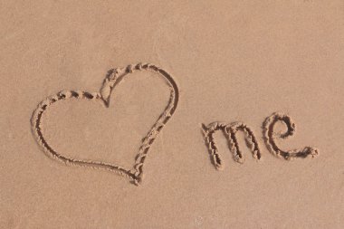 Love me written on  sand on a beach clipart
