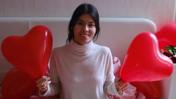 Joyful girl waving red balloons valentines day — Stock Video