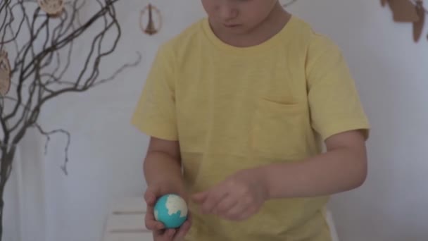 Joyeux Pâques. Le petit garçon épluche l'oeuf de Pâques — Video