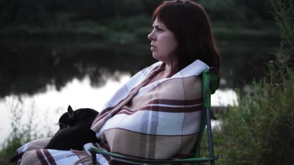 Women Sitting on the Bank of the River. on Lap Dog Lying — Stock Video