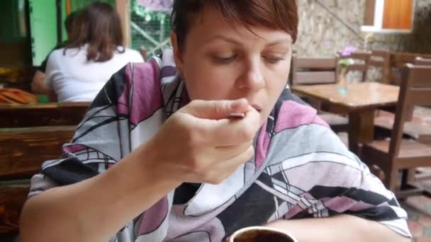 Young Woman Eating Food From a Pot — Stock Video